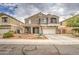 Attractive two-story house features low-water landscaping, a covered porch, and a convenient driveway at 7013 W Branham Ln, Laveen, AZ 85339