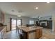 Bright open kitchen featuring a center island with a sink and a view into the living room at 7013 W Branham Ln, Laveen, AZ 85339