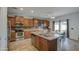 Open kitchen featuring an island with stainless steel sink, dining table, and modern appliances at 7013 W Branham Ln, Laveen, AZ 85339