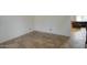 Corner view of a room showcasing tiled flooring and partial view into adjacent living space at 7013 W Branham Ln, Laveen, AZ 85339