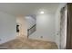 Open living area with tiled flooring, a staircase, and a view of the adjacent room at 7013 W Branham Ln, Laveen, AZ 85339