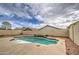 Backyard pool with rock landscaping with water feature and privacy wall at 7013 W Branham Ln, Laveen, AZ 85339