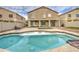 Sparkling backyard pool offers a refreshing oasis with a spacious deck, perfect for summer gatherings at 7013 W Branham Ln, Laveen, AZ 85339