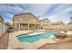 Backyard pool featuring rock landscaping and a built in fire pit with lounge chairs at 7013 W Branham Ln, Laveen, AZ 85339