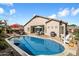 A refreshing pool is surrounded by outdoor seating and green landscaping at 7161 W Saddlehorn Rd, Peoria, AZ 85383