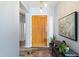 Inviting entryway with a wooden front door, stylish decor, a console table, and a colorful rug at 7161 W Saddlehorn Rd, Peoria, AZ 85383