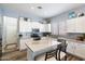 Bright kitchen featuring a center island, stainless steel appliances, white cabinets, and modern finishes at 7161 W Saddlehorn Rd, Peoria, AZ 85383