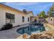 Sparkling backyard pool with rock features, surrounded by lush landscaping and a covered patio at 850 E Vaughn Ave, Gilbert, AZ 85234