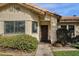 Inviting front exterior showcasing a tiled roof, manicured shrubs, and a secure screen door at 850 E Vaughn Ave, Gilbert, AZ 85234