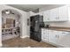 White kitchen featuring modern appliances and an arched entry to the dining room at 850 E Vaughn Ave, Gilbert, AZ 85234