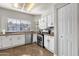 Bright, functional kitchen with white cabinets, a window view, and stainless steel appliances at 850 E Vaughn Ave, Gilbert, AZ 85234