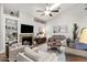 Bright living room with a fireplace, built in shelves and ceiling fan offers a cozy atmosphere at 850 E Vaughn Ave, Gilbert, AZ 85234