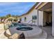 Backyard pool and spa with rock waterfall feature, adjacent to the covered patio at 850 E Vaughn Ave, Gilbert, AZ 85234