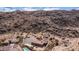 Aerial view of a desert home with a pool, lush landscaping, an outdoor patio, and mountain backdrop at 8612 S 30 Th Way, Phoenix, AZ 85042