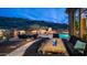 Backyard seating area with a fire pit and outdoor kitchen near the pool and desert landscape at 8612 S 30 Th Way, Phoenix, AZ 85042