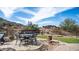 Backyard featuring outdoor dining, desert landscaping, and desert hillside backdrop at 8612 S 30 Th Way, Phoenix, AZ 85042