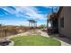 Backyard with artificial grass, rock landscaping, an upper deck and a spiral staircase at 8612 S 30 Th Way, Phoenix, AZ 85042