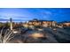 Desert landscaped backyard with a covered patio area, lounge chairs and mountain views in the background at 8612 S 30 Th Way, Phoenix, AZ 85042