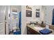 Charming bathroom with granite countertop, decorative wall art and a view through the window at 8612 S 30 Th Way, Phoenix, AZ 85042