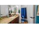 Bathroom featuring granite countertops, dark wood cabinets, single vanity, and shower behind a blue curtain at 8612 S 30 Th Way, Phoenix, AZ 85042