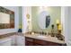 Charming powder room with granite vanity and decorative mirror creating a warm inviting space at 8612 S 30 Th Way, Phoenix, AZ 85042