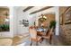 Elegant dining room with a chandelier, rustic wall accents, and a set dining table for gatherings at 8612 S 30 Th Way, Phoenix, AZ 85042