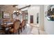 Formal dining room featuring a wood table, upholstered chairs, brick accent wall, and stylish chandelier at 8612 S 30 Th Way, Phoenix, AZ 85042