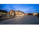 Desert home with three-car garage featuring natural landscaping with desert plants and a long concrete driveway at 8612 S 30 Th Way, Phoenix, AZ 85042