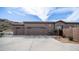 Exterior of desert home featuring three-car garage and mature desert landscaping at 8612 S 30 Th Way, Phoenix, AZ 85042