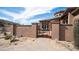 Charming entry gate leading to a beautiful desert home with blue sky at 8612 S 30 Th Way, Phoenix, AZ 85042