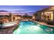 Backyard oasis featuring a sparkling pool and spa, surrounded by desert landscape and lounge chairs and mountain views at 8612 S 30 Th Way, Phoenix, AZ 85042