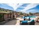 Seating area next to a custom pool, outdoor cooking area, and mountain views at 8612 S 30 Th Way, Phoenix, AZ 85042