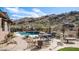 Backyard pool with cascading waterfall, outdoor dining, and desert landscaping at 8612 S 30 Th Way, Phoenix, AZ 85042