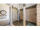 Walk-in shower with glass enclosure featuring neutral-toned stone-look tile surround at 8612 S 30 Th Way, Phoenix, AZ 85042