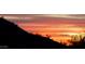 Sunset over hillside with some shrubs and cacti in foreground, pink and orange sky at 8612 S 30 Th Way, Phoenix, AZ 85042