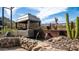 Unique backyard water feature with lush desert landscaping and peaceful setting at 8612 S 30 Th Way, Phoenix, AZ 85042