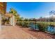 Serene backyard featuring beautiful pond views, privacy landscaping, and patio space at 9633 S 51St St, Phoenix, AZ 85044