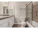 Bathroom features a large vanity, framed mirrors, and a shower over tub with glass doors at 9633 S 51St St, Phoenix, AZ 85044