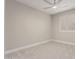 Bright bedroom featuring a ceiling fan, white plantation shutters, and neutral walls at 9633 S 51St St, Phoenix, AZ 85044