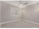 Bright bedroom featuring white walls, a ceiling fan, and white plantation shutters at 9633 S 51St St, Phoenix, AZ 85044