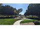 Beautiful community fountain surrounded by lush green grass and mature trees on a sunny day at 9633 S 51St St, Phoenix, AZ 85044