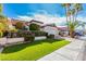 Charming home featuring lush landscaping, palm trees, and well-manicured lawn, creating inviting curb appeal at 9633 S 51St St, Phoenix, AZ 85044