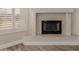 Close up on the fireplace in a living room, featuring wood floors and plantation shutters at 9633 S 51St St, Phoenix, AZ 85044