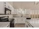 Bright kitchen featuring white cabinets, granite countertops, an island, and stainless-steel appliances at 9633 S 51St St, Phoenix, AZ 85044