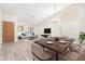 Bright living room featuring wood floors, neutral paint, vaulted ceilings, and plantation shutters at 9633 S 51St St, Phoenix, AZ 85044