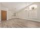 Bright living room featuring wood floors, neutral paint, vaulted ceilings, and plantation shutters at 9633 S 51St St, Phoenix, AZ 85044