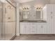 Main bathroom featuring a double sink vanity, built-in cabinets, and glass shower at 9633 S 51St St, Phoenix, AZ 85044