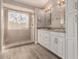 Main bathroom featuring a double sink vanity, built-in cabinets, and glass shower at 9633 S 51St St, Phoenix, AZ 85044