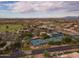 Community aerial view of lush greenery, tennis courts and a large lake with luxury houses surrounding this quiet neighborhood at 9638 E Tranquility Way, Sun Lakes, AZ 85248