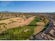 High-angle view of a golf course and surrounding neighborhood showcasing the lush landscaping and scenic beauty of the community at 9638 E Tranquility Way, Sun Lakes, AZ 85248